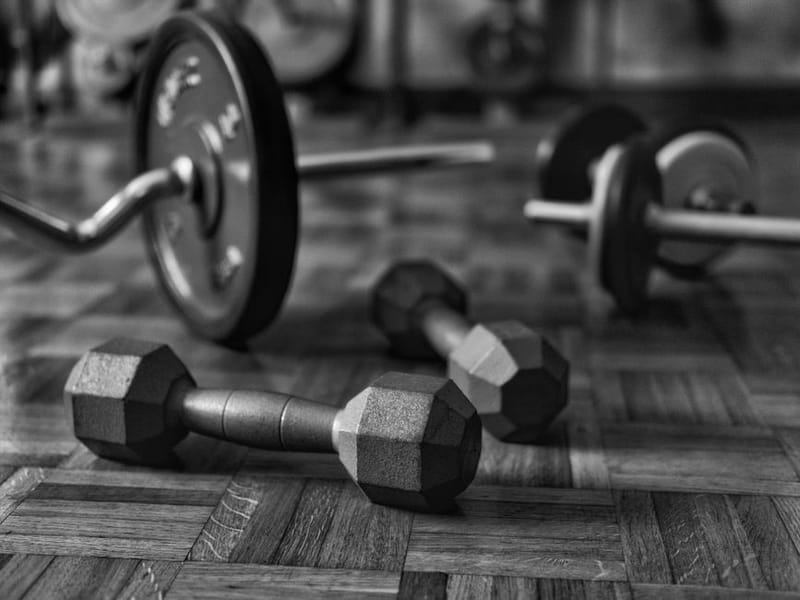 Dumbbells resting on a wooden floor