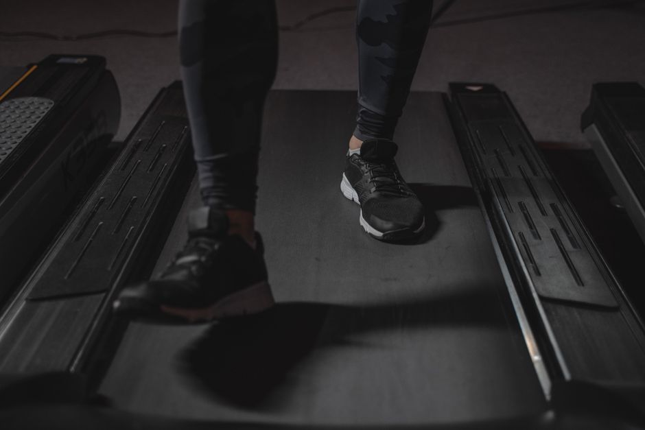 Person using a walking pad treadmill in a living room