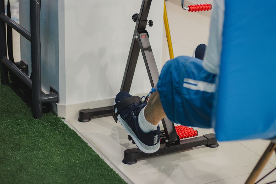 Under-desk pedal exerciser in use at a home office desk