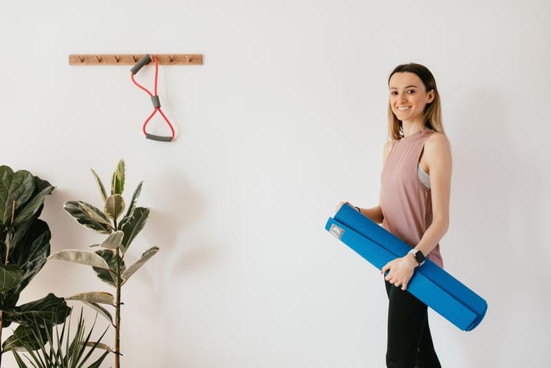 Yoga mat and resistance bands hung on wall hooks to save floor space